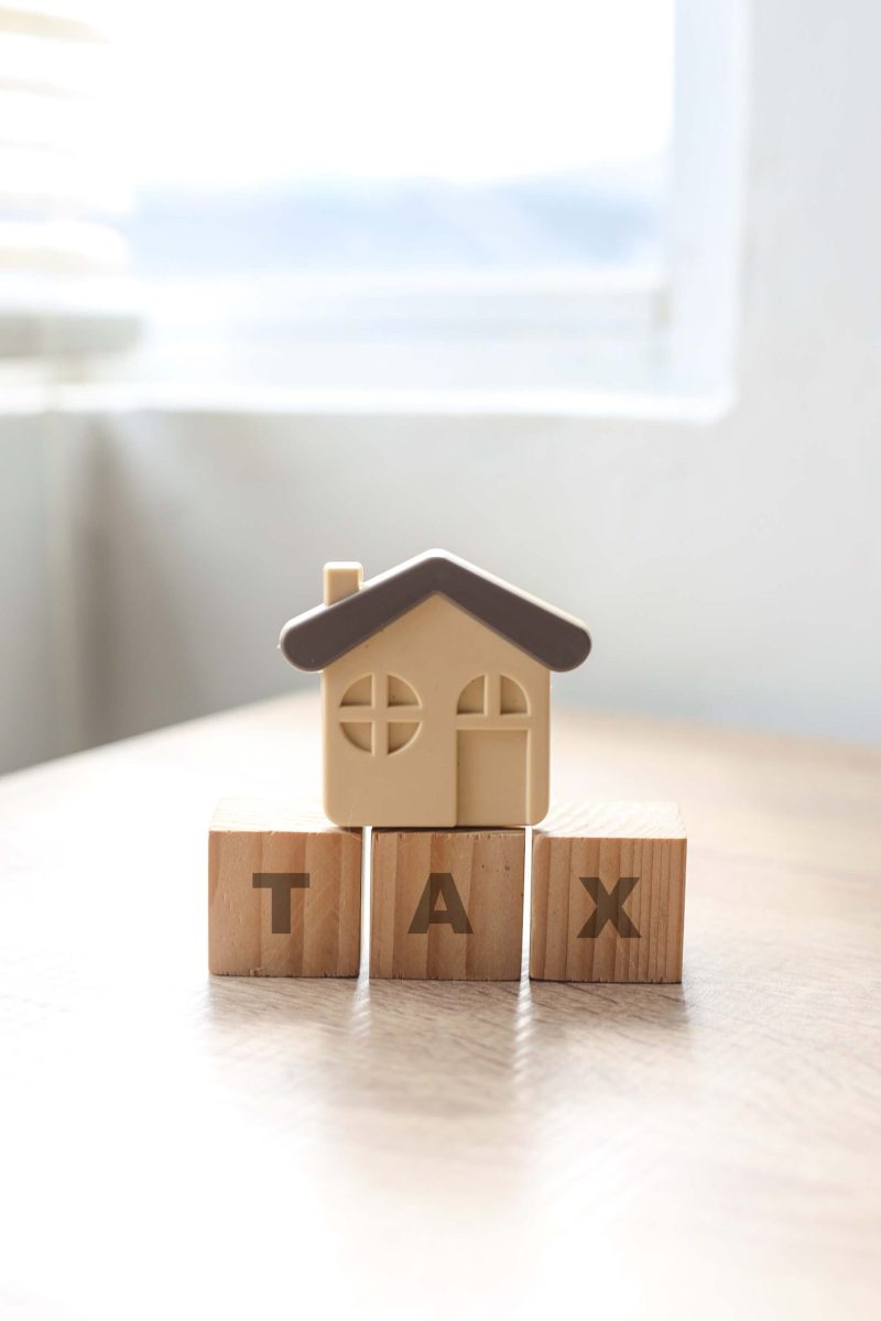 tax-words-with-a-miniature-house-on-wooden-desk-p-2023-04-26-07-28-43-utc (1)